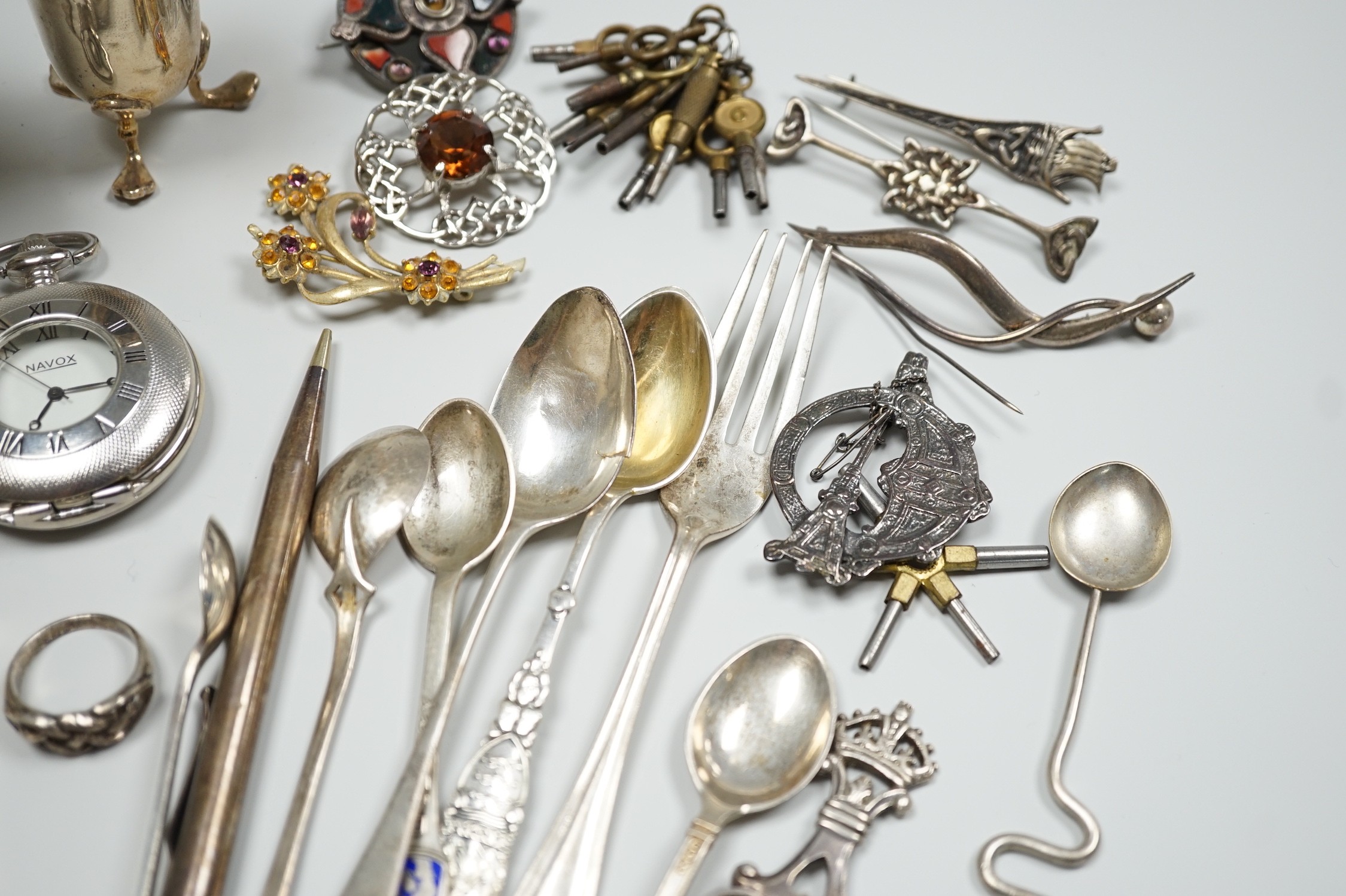 Sundry small silver including two sauceboats, napkin rings, mounted glass condiment bottle, pepperette, pair of silver gilt preserve spoons, minor flatware including white metal, a 1920's Georg Jensen silver cream ladle,